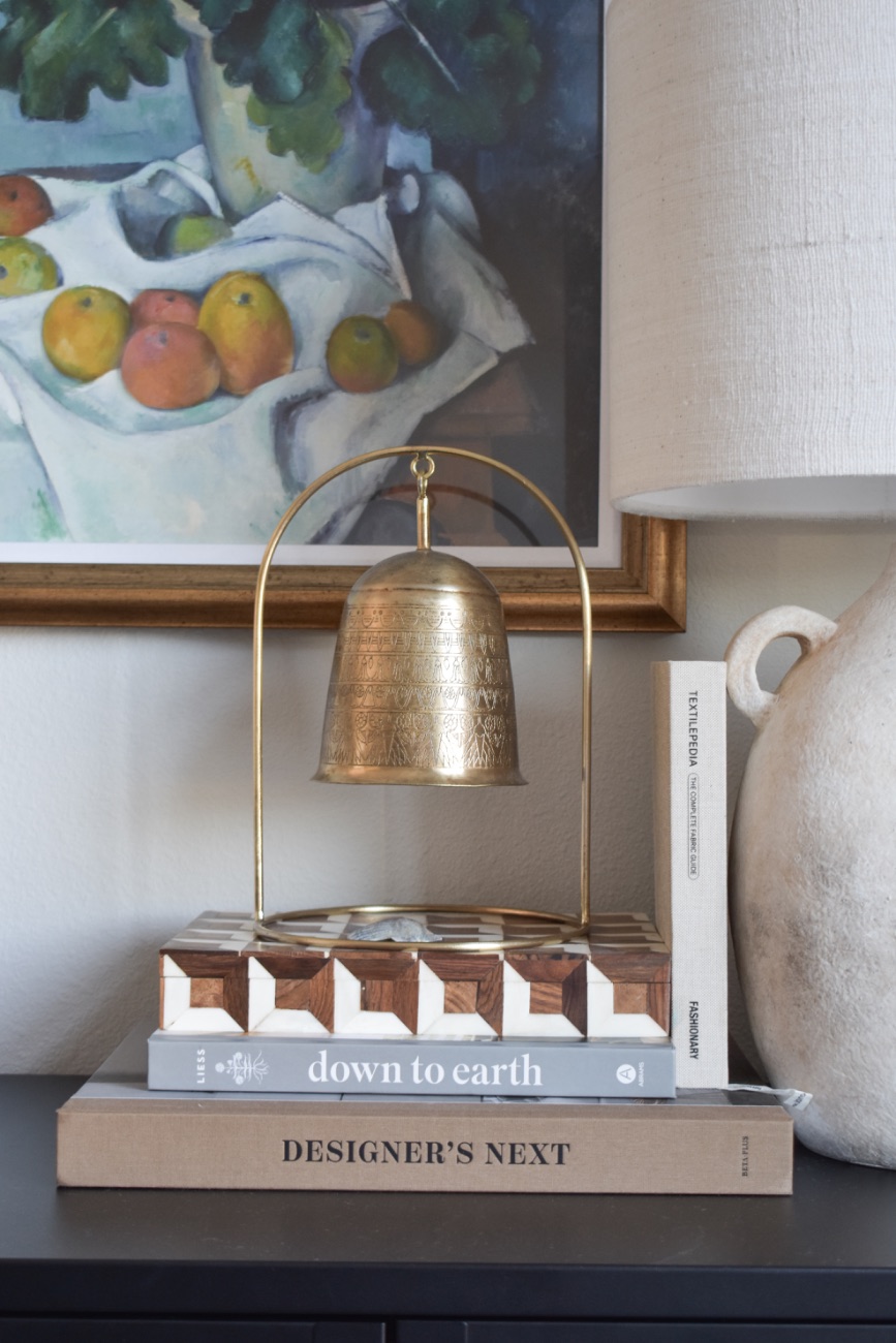 Styled shelf vignette with books and ceramics