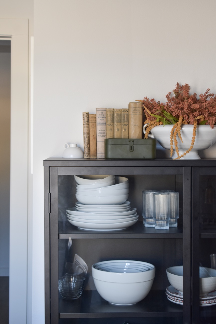 Dark cabinet styled with ceramics